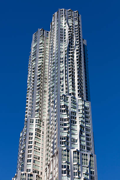 8 Spruce Street, Beekman Tower, Manhattan New York New York, United States - April 27, 2014: An apartment tower 8 Spruce Street in New York City also called Beekman Tower or New York by Gehry. It is the tallest residential tower in the world designed by Frank Gehry. It is a 76-story skyscraper situated between William and Nassau Streets, in Lower Manhattan, just south of City Hall Park and the Brooklyn Bridge. frank gehry building stock pictures, royalty-free photos & images