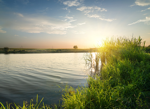 Quiet river at sunset in late summer