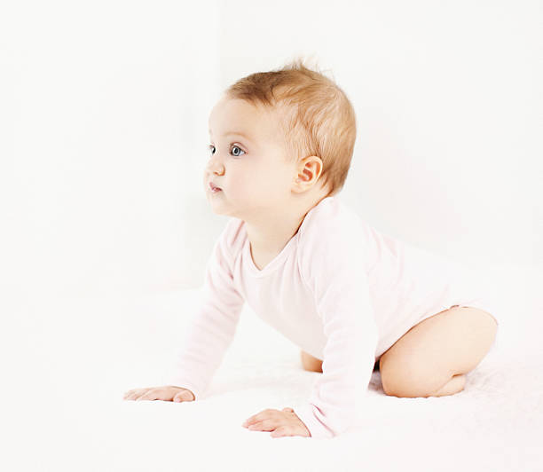istock Cute baby girl crawling on a bed. 514316494