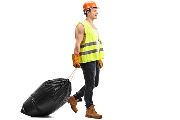 istock Waste collector dragging a bag of trash 514316552