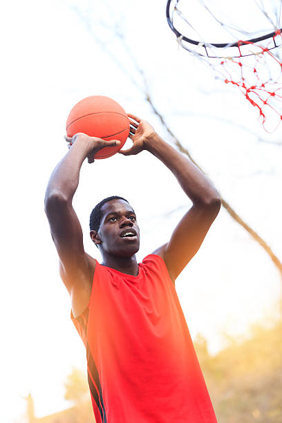 istock Basketball player throwing to score 514316710