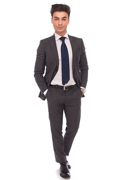istock confident business man standing with hands in pockets 514317622