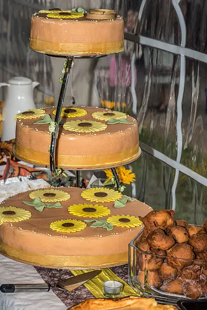 Wedding cake decorated with sunflowers from marzipan