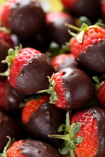 istock Fresh strawberries dipped in dark chocolate background 514317908