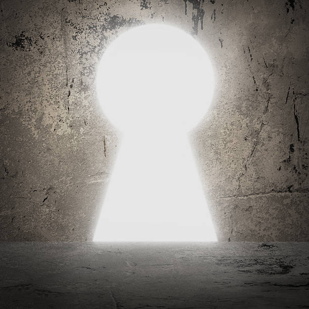 istock In concrete wall doorway as keyhole. Bright light 514318477