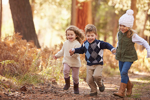 istock Group Of Young Children Running Along Path In Autumn Forest 514318518