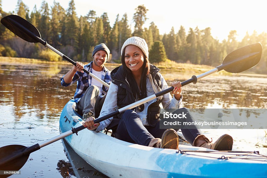 African American Couple Rowing Kayak On Lake Kayaking Stock Photo