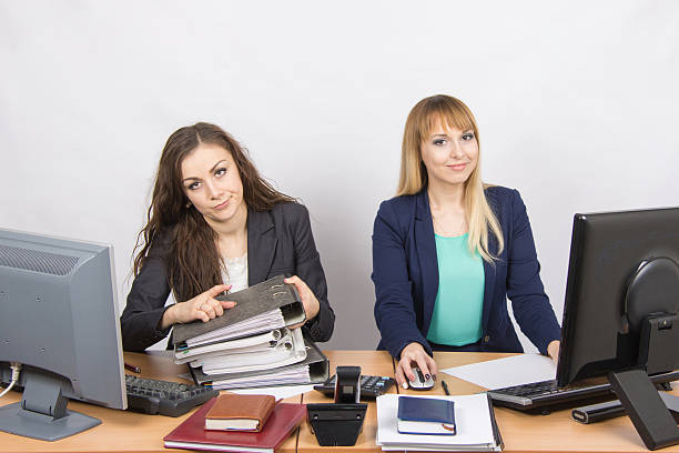 istock Female colleagues in the office, one littered with paper documents 514319120