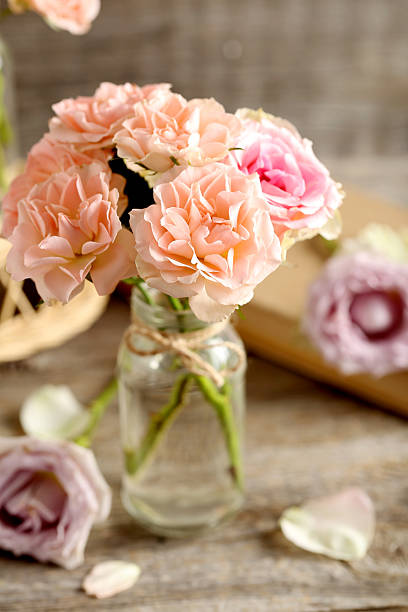 istock Bouquet of beautiful roses on a grey wooden table 514320162