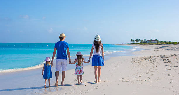 istock Family of four on beach vacation 514320419