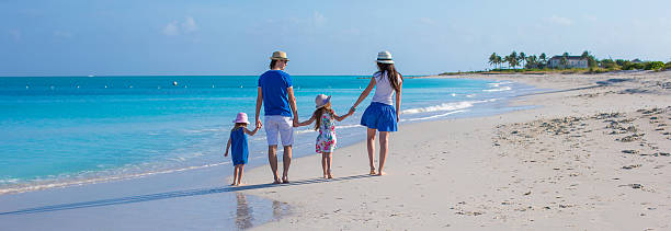 istock Happy family of four on beach vacation 514320421