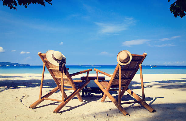 istock hats on chairs of tropical sand beach 514321064