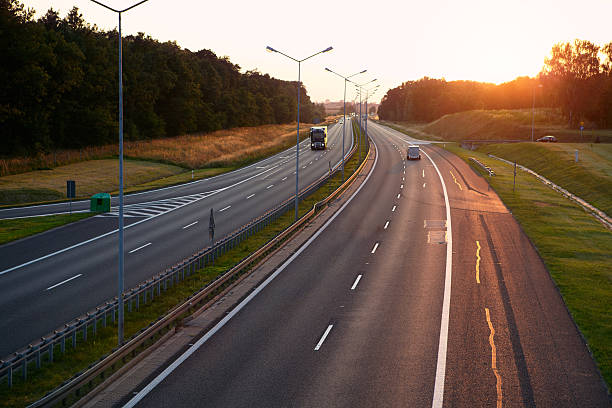 istock Motorway with cars silhouettes during sunset 514322785