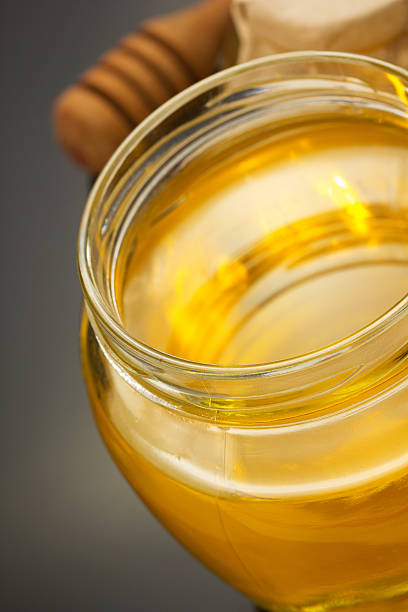 istock glass jar of honey on black 514322854