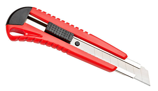 istock Red paper knife isolated on white background 514323311