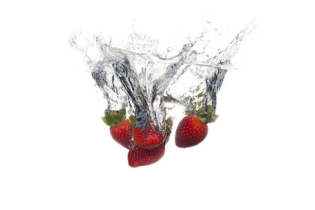 istock Fresh fruits dropped into water with splash on white background 514324305