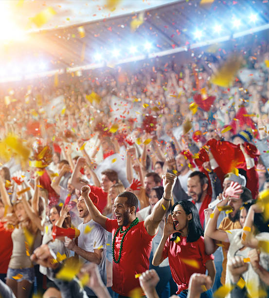 Sport fans: Happy cheering crowd :biggrin:On the foreground a group of cheering fans watch a sport championship on stadium. Everybody are happy. People are dressed in casual cloth. Colourful confetti flies int the air. football fans in stadium stock pictures, royalty-free photos & images