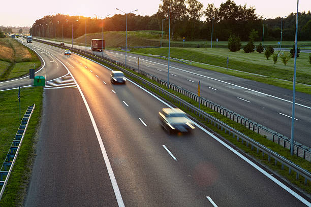 istock Motorway with cars silhouettes during sunset 514324967