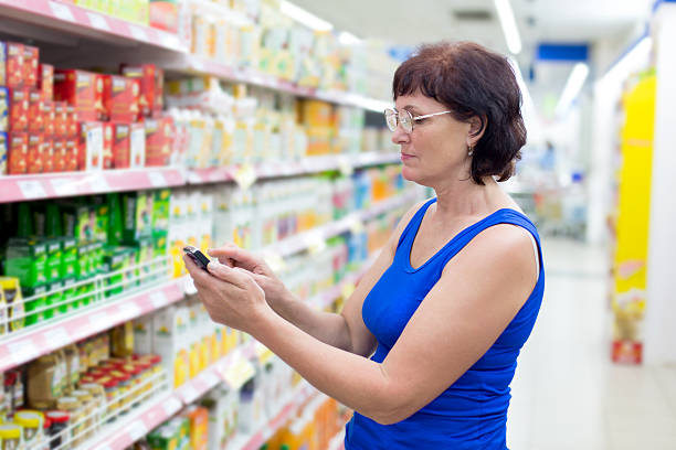 istock woman writes SMS in the supermarket 514326009