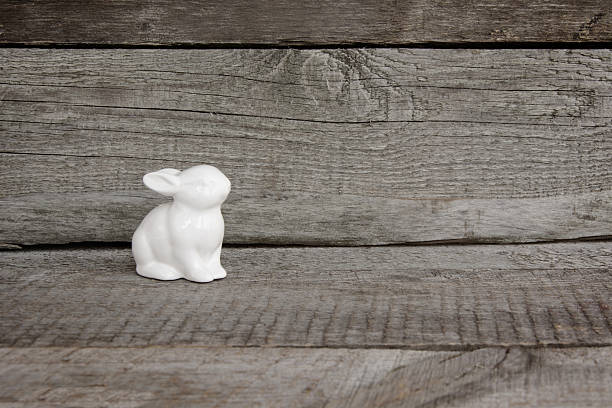 istock White rabbit on vintage wooden background.  Easter Background. 514326408
