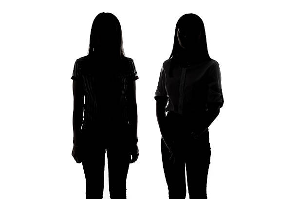 istock Silhouette of two young women 514327078