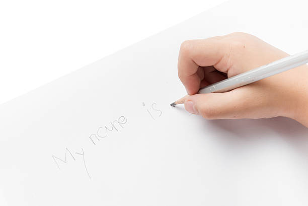 istock Hand girl write his name by pencil. 514329162