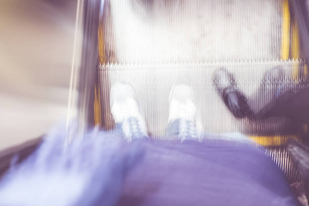 Blurred background, Motion blur of looking down at foot on escalator.