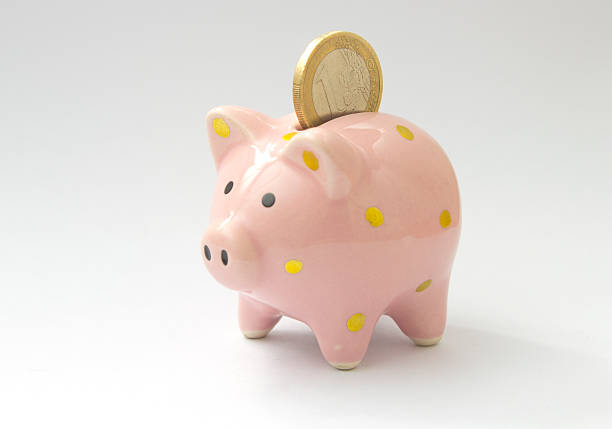 istock 1 euro coin falling in piggy bank 514331172