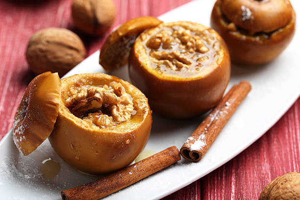 istock Baked apples on plate on red wooden table 514331328