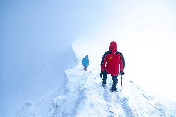 istock 2 men descending a glacier peak into the clouds 514331422