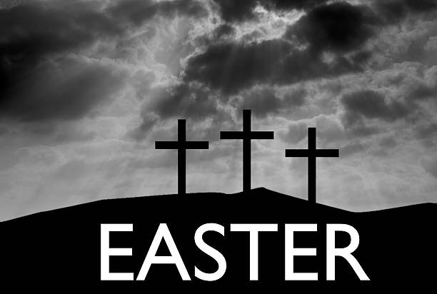 Three Easter crosses on hill with easter text stock photo