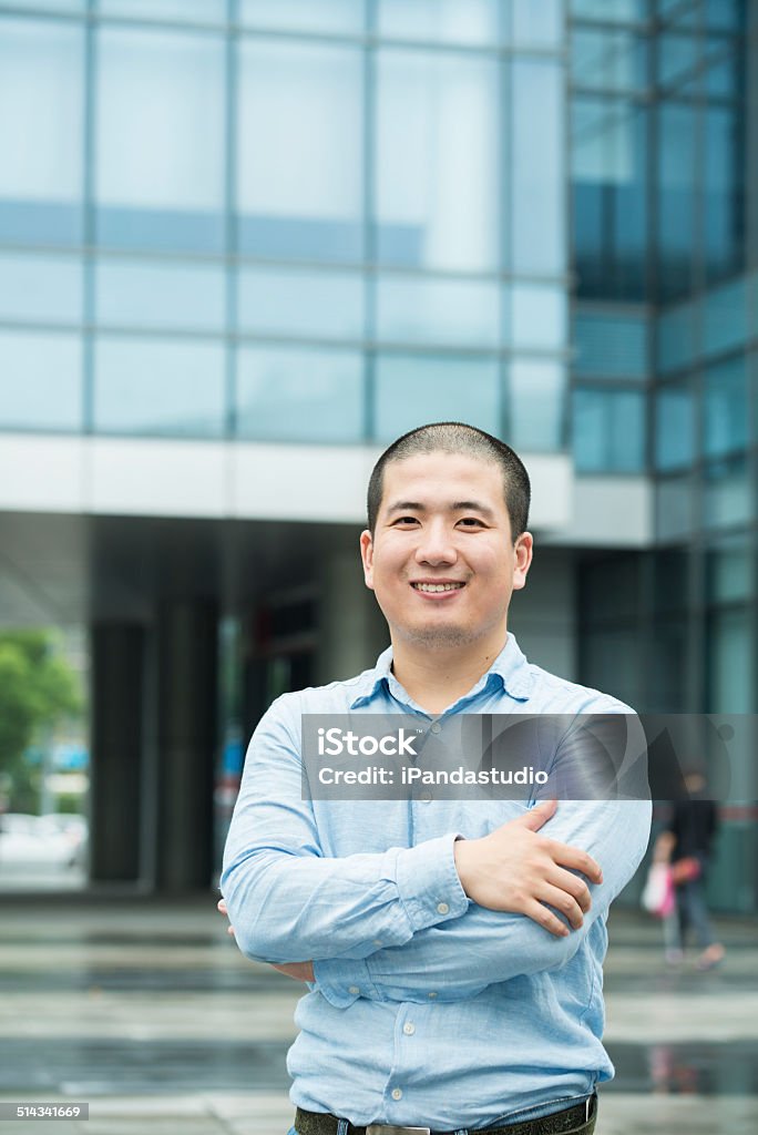 smiling Asian businessman smiling Asian businessman looking at camera Adult Stock Photo