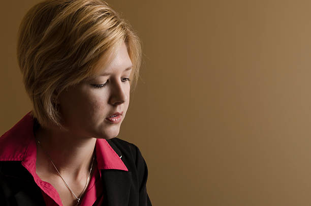 Young Blond Woman Deep in Thought stock photo