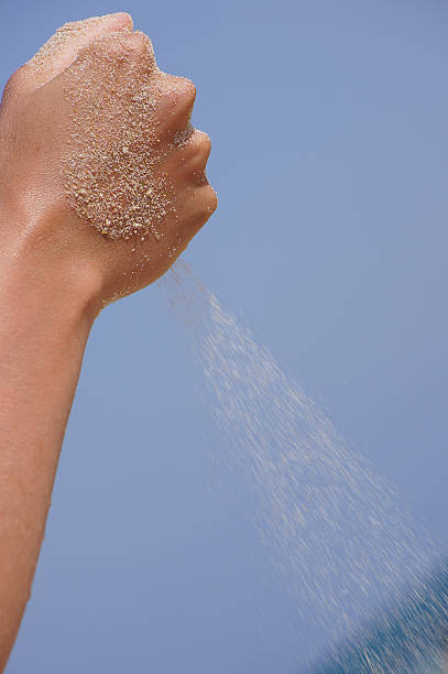 istock sand running through hands as a symbol for time running 514343839