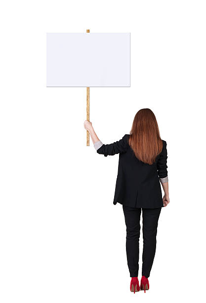 istock Back view business woman showing sign board. 514345839