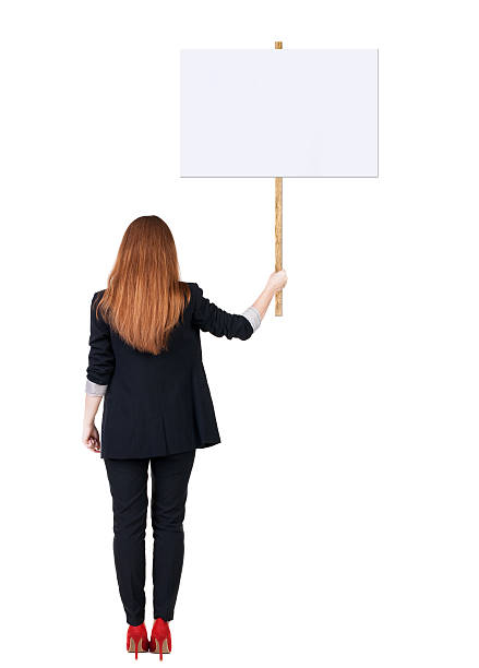 istock Back view business woman showing sign board. 514346029