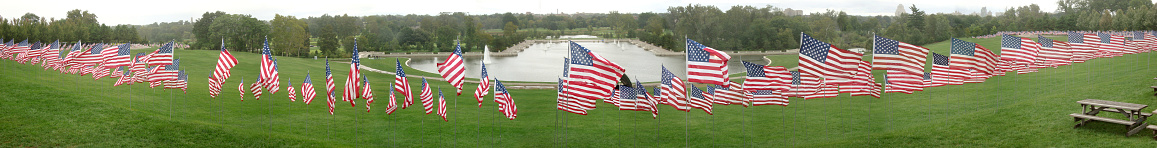 In this panorama hundreds of American Flags surround the top of art hill in Forest Park in St. Louis, Missouri in preparation for a service in rememberance of September 11th on the 13th anniversary of the 9/11 attack.