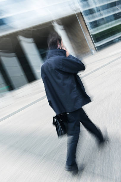 istock Businessman walking and talking on cellphone 514346749
