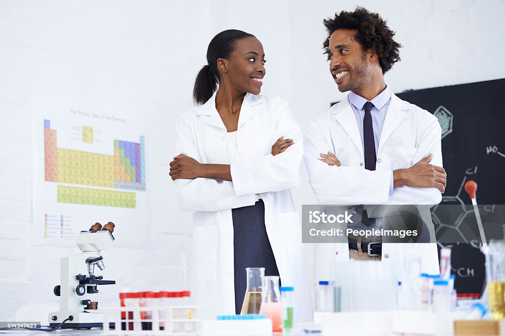 Lab partners bonding Shot of two scientists standing together in their lab Adult Stock Photo