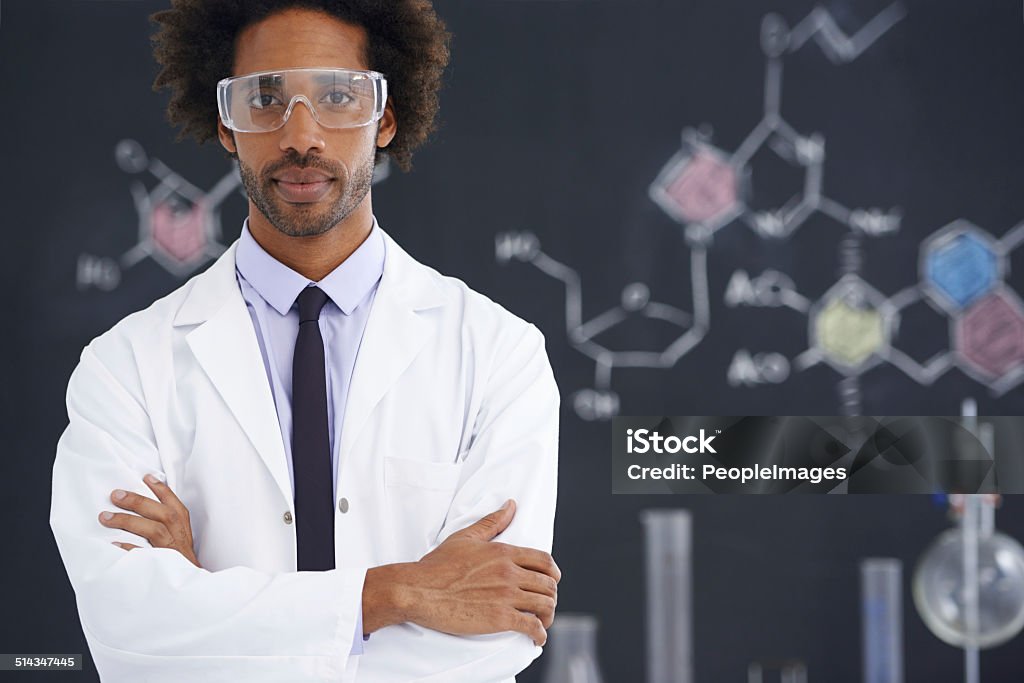 He's always had an analytical mind A male scientist standing in front of a blackboard filled with drawings of chemical bonds African-American Ethnicity Stock Photo