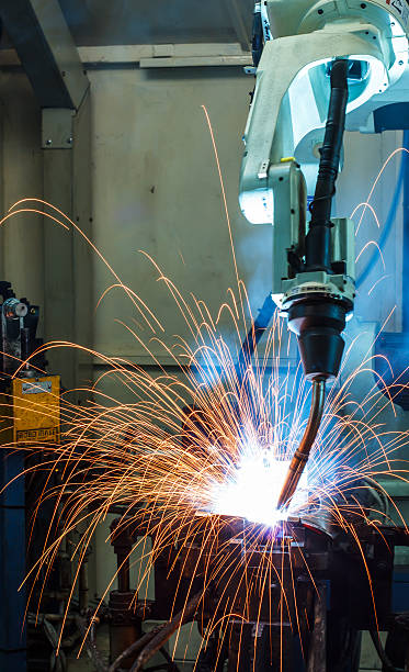 istock Robots welding in a car factory 514360189