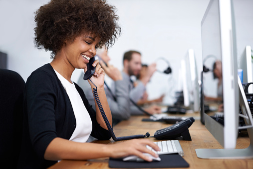 Shot of a woman working with her colleagues in the background