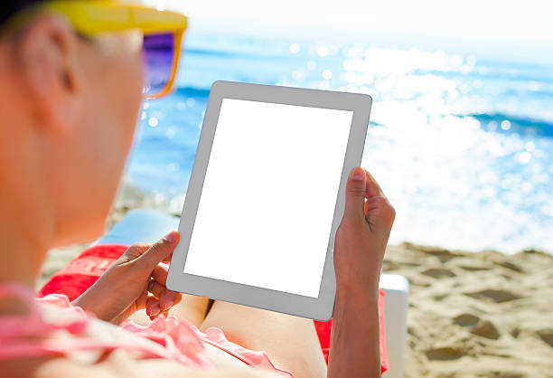 istock Woman with tablet pc at the beach 514363351