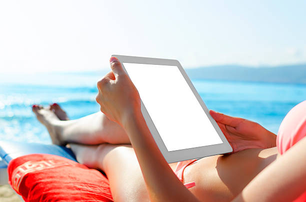 istock Woman with tablet pc at the beach 514363363