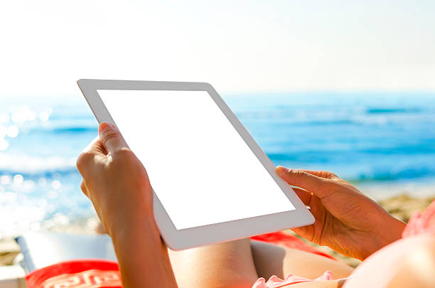 istock Woman with tablet pc at the beach 514363375