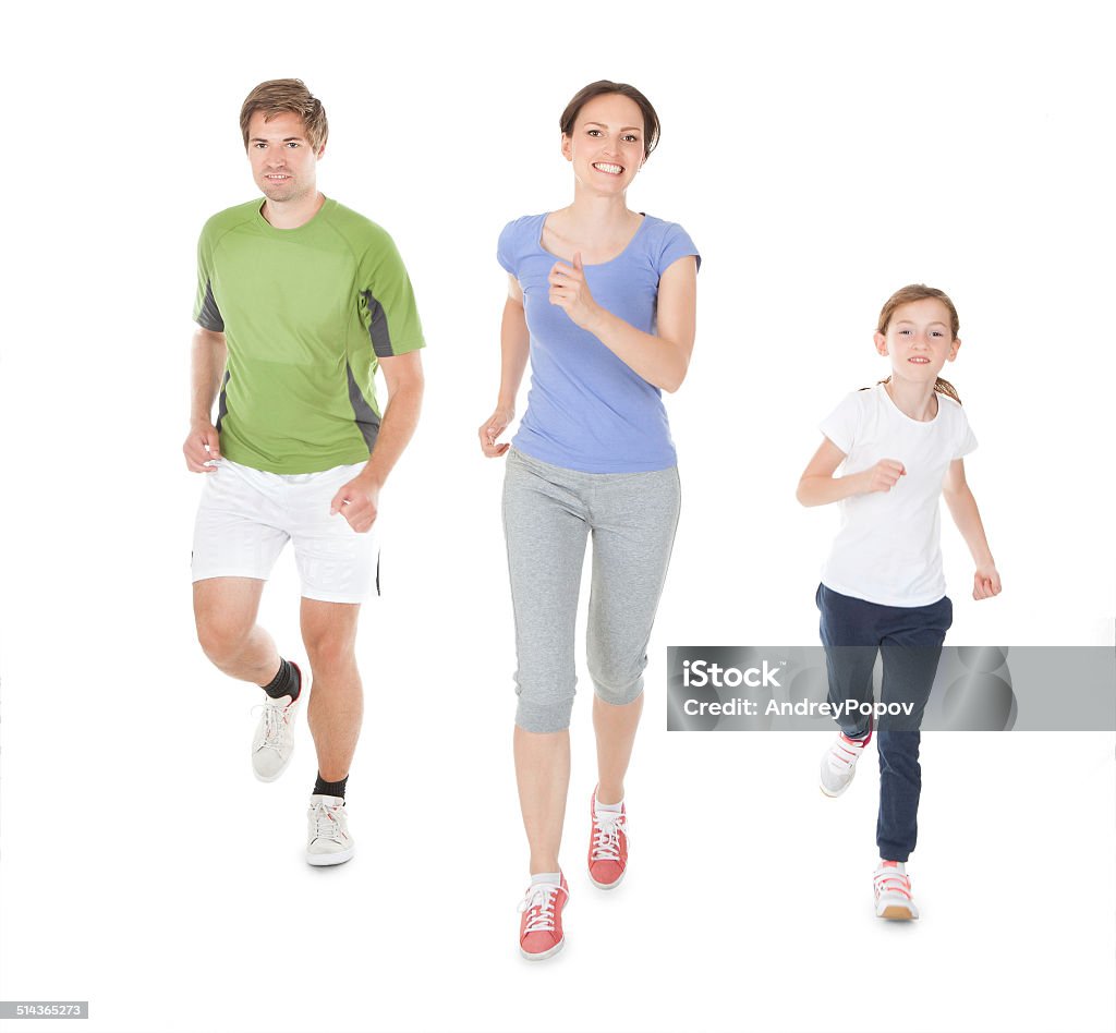 Family Jogging Against White Background Full length portrait of family in sportswear jogging against white background Jogging Stock Photo