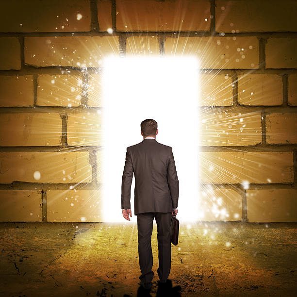 istock Businessman in suit with briefcase stepping through door 514365943