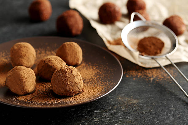 istock Sweet chocolate truffle on a black wooden table 514366300