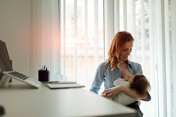istock Mother Working and breastfeeding her baby 514366438
