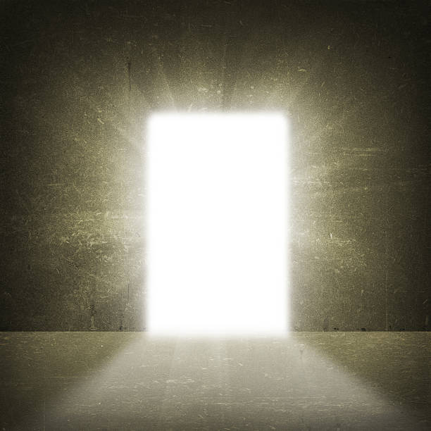 istock In concrete wall doorway with bright light 514366451